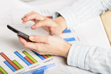 Fototapeta premium Businesswoman hands analyzing financial statistics.