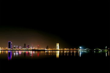 Fototapeta premium Broad view of Bahrain skyline and reflection