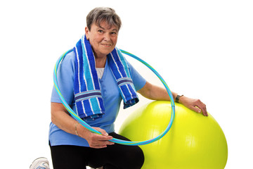 Seniorin mit Gymnastikball und Hula-Hoop
