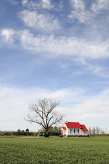 Rural Church with Bright Red Roof on Sunny Day