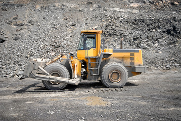 Wheel bulldozer working in career.