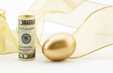 American currency with nest egg and gold ribbon