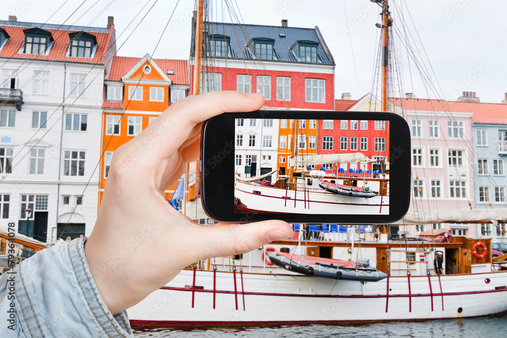 Poster tourist taking photo of nyhavn waterfront