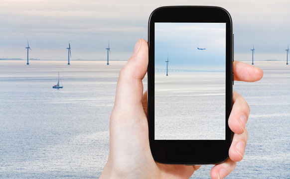 tourist shooting photo of Middelgrunden wind farm