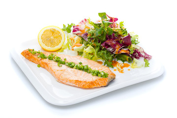 Salmon stake with green onion and salad mix isolated