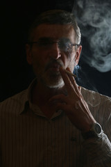 Middle aged bearded man smoking a cigarette