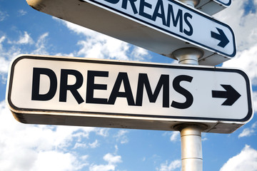 Dreams direction sign on sky background