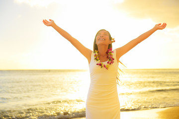 Fototapeta na wymiar Happy carefree woman free in Hawaii beach sunset