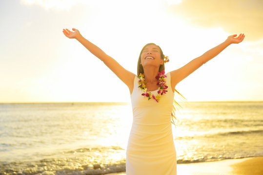 Happy carefree woman free in Hawaii beach sunset