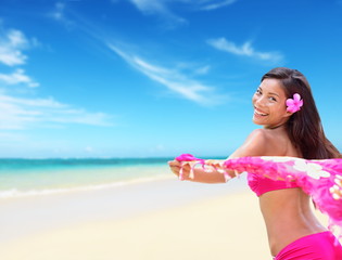 Happy carefree hawaiian woman relaxing on beach