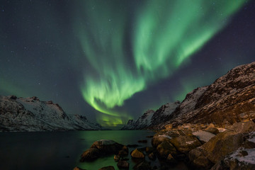 Incredible Aurora Borealis over night sky in Arctic