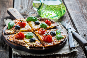 Cutting homemade pizza on old table