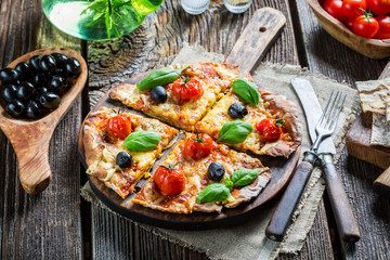 Freshly baked pizza split and given on baking paper