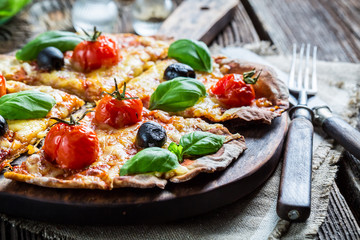 Sprinkling flour on fresh pizza dough