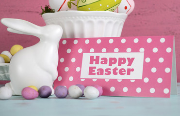 Easter bunny and bowls of eggs on pink and blue table