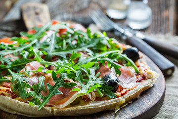 Closeup of homemade pizza with tomato and basil