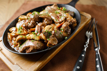 Liver baked with mushrooms, bacon and herbs