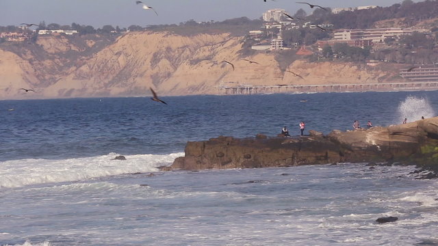 Waves crashing on rocks and beach in San Diego