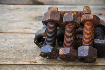 Old bolts or dirty bolts on wooden background