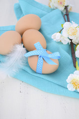 Obraz na płótnie Canvas Easter blue and white table with fresh eggs