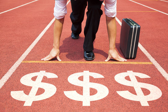 businessman getting ready for race on the track