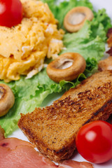 Scrambled eggs with white mushrooms and cherry tomatoes