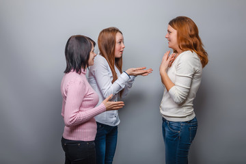 Three young girls talking and European appearance surprised on a
