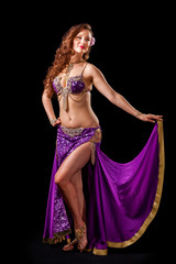 Beautiful belly dancer  holding out skirt