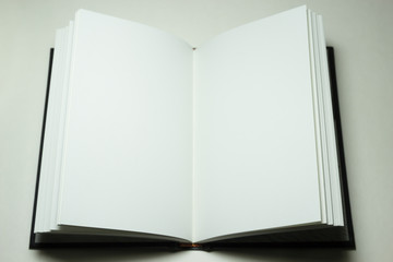 open hardcover book with blank pages on white background