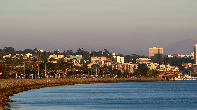 Pan shot of San Diego Bay with downtown skyline in the evening