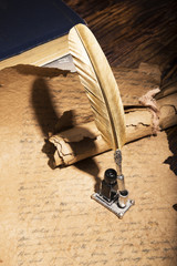 Vintage golden pen and ancient manuscripts