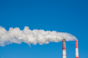 Smoking chimneys against the blue sky