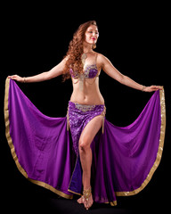 Beautiful belly dancer  holding out skirt