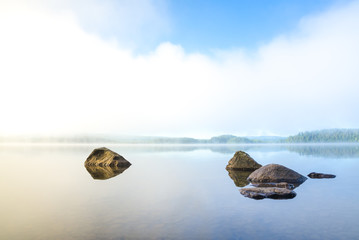 Early and harmonious morning with fog over the lake - obrazy, fototapety, plakaty