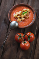 Gazpacho over dark rustic wooden background, studio shot
