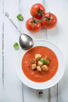 Still life with Gazpacho, white wooden background, above view