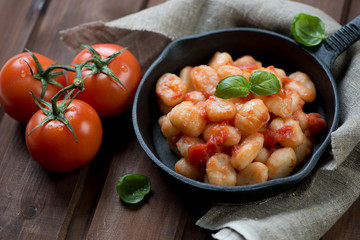 Italian gnocchi with tomato sauce and basil, studio shot