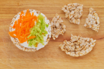 Rice cakes with white low fat cheese spread, carrot and cucumber