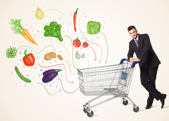 Businessman with shopping cart with vegetables