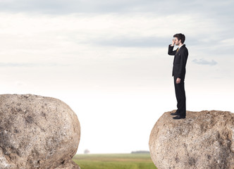 Businessman on rock mountain