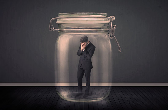 Businessman Trapped Into A Glass Jar Concept