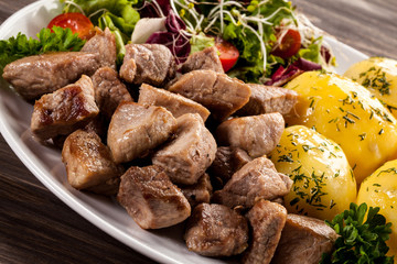 Grilled meat with boiled potatoes and vegetables