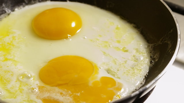 Fried eggs preparation on a pan, time lapse