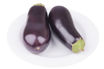 two raw eggplant on a plate