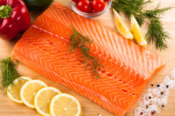 Fresh raw salmon fillet on cutting board