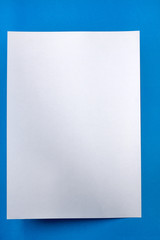 White piece of paper over a blue background.