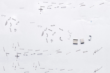 White piece of paper with staple needles.