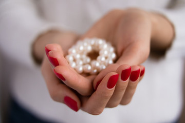 Pearls in female hands