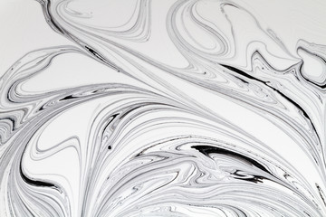 Mix of a white and black paint, closeup.