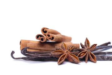 Close view of vanilla pods, anise, stars and cinnamon sticks.